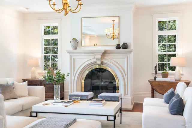 a living room with furniture a large window and a fireplace