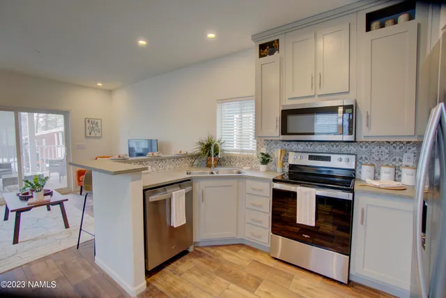 a living room with furniture a flat screen tv and a large window