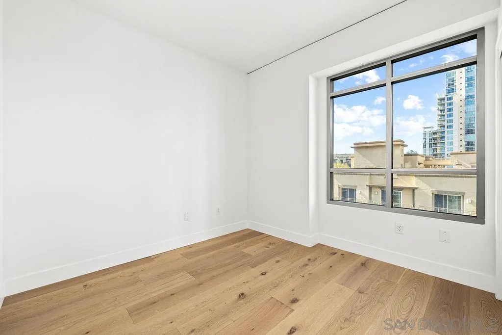 801 Ash Street, Unit 402 San Diego, CA 92101 - Photo 23 of 31 a view of empty room with wooden floor and fan