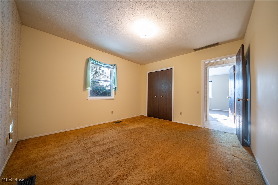 11702 Clark Road Chardon, OH 44024 - Photo 20 of 29 Bedroom 1 with a text light carpet, and a closet