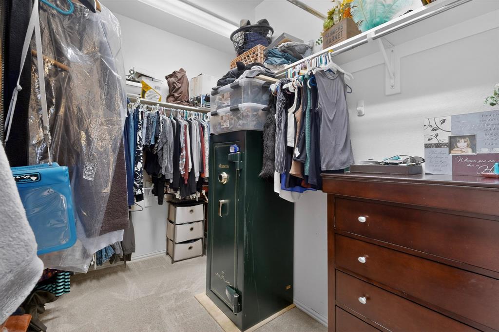 4004 White Porch Road Plano, TX 75024 - Photo 35 of 40 a view of walk in closet with clothes and shoes