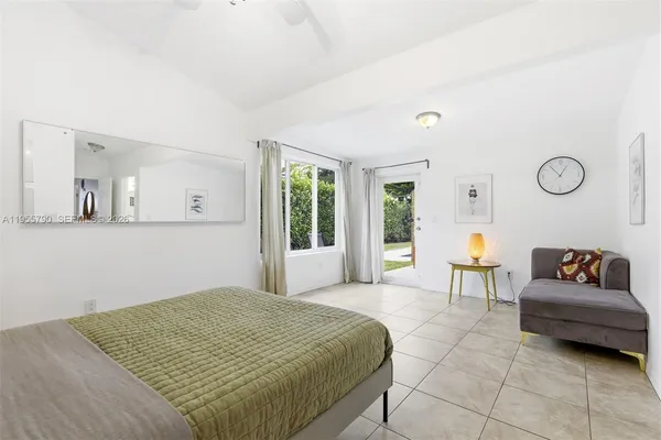 a bedroom with a bed and a couch