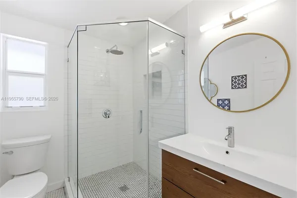 a bathroom with a toilet sink and shower