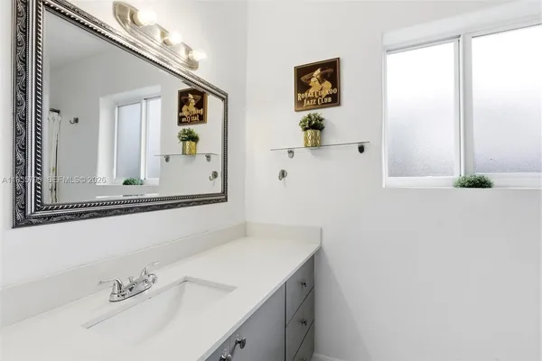 a bathroom with a sink and a mirror