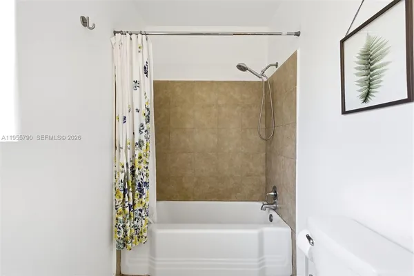 a bathroom with a shower and a tub