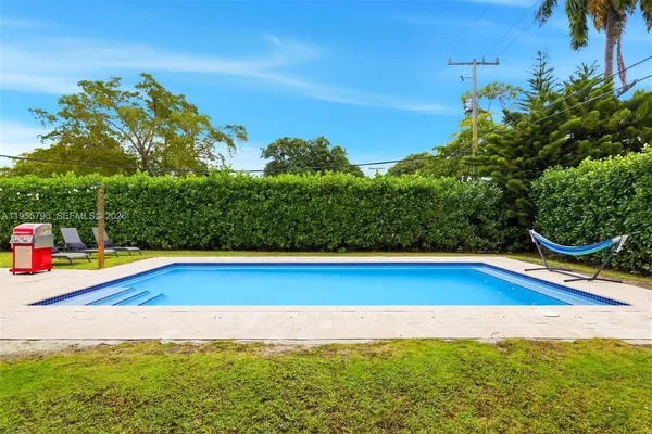 a view of a swimming pool with an outdoor space and seating area