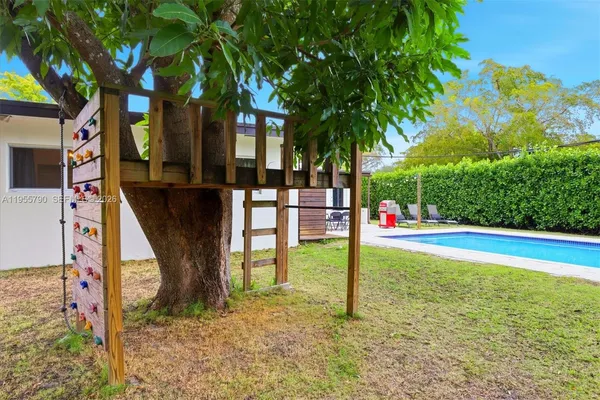 a view of swimming pool with a tree