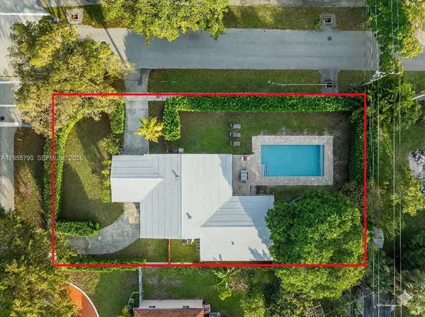 an aerial view of a house with a yard and lake view