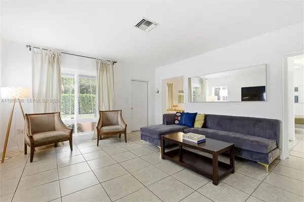a living room with furniture and a window