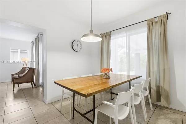 a view of a dining room with furniture and window