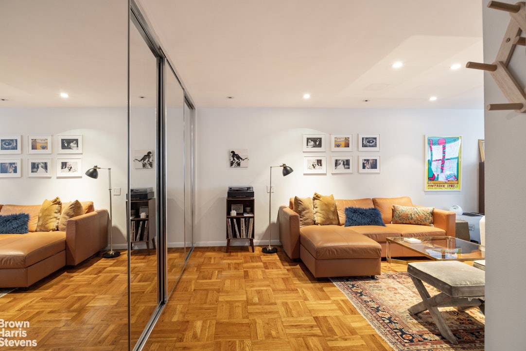 239 East 79th Street, Unit 2M Manhattan, NY 10075 - Photo 2 of 10 a living room with furniture and a couch