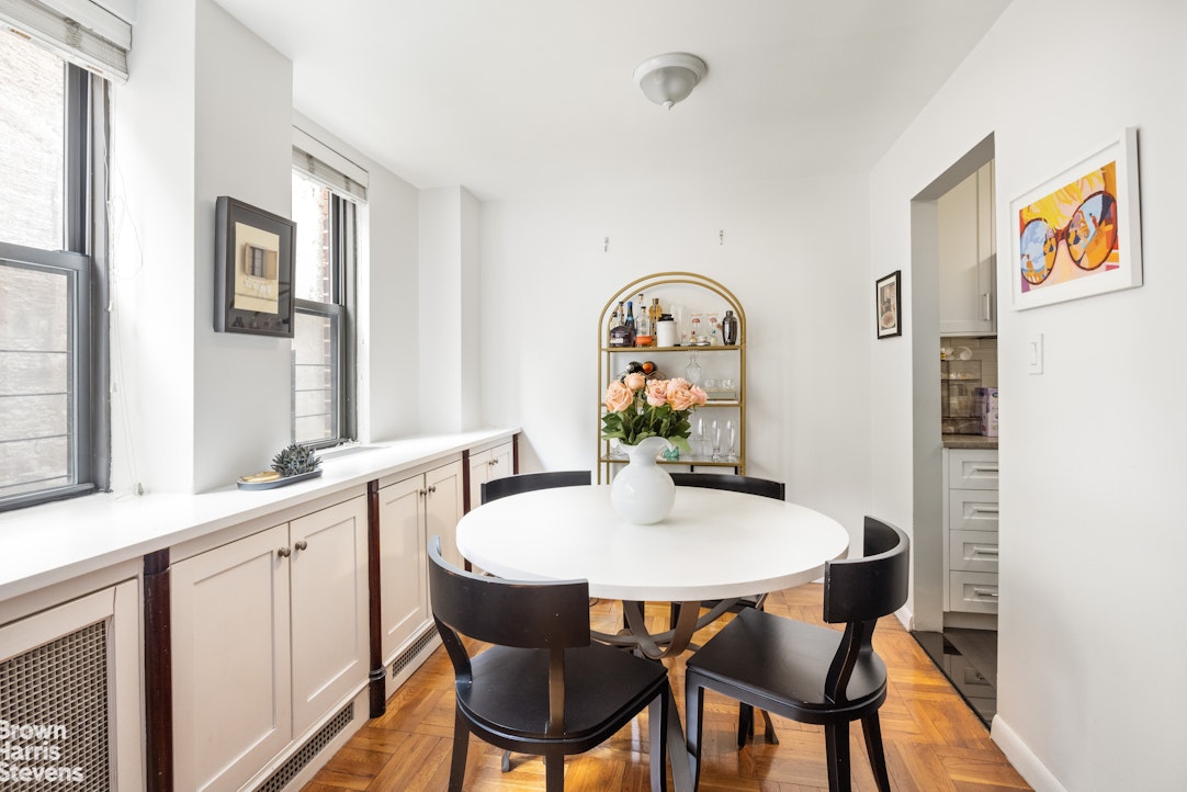 239 East 79th Street, Unit 2M Manhattan, NY 10075 - Photo 3 of 10 a dining room with furniture and window