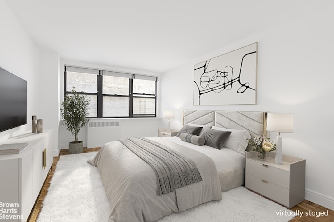 239 East 79th Street, Unit 2M Manhattan, NY 10075 - Photo 5 of 10 a bedroom with a large bed and a flat tv screen on dresser
