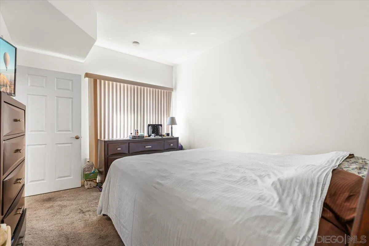 2715 Lake Pointe Drive, Unit 116 Spring Valley, CA 91977 - Photo 11 of 25 a bedroom with a bed and a window