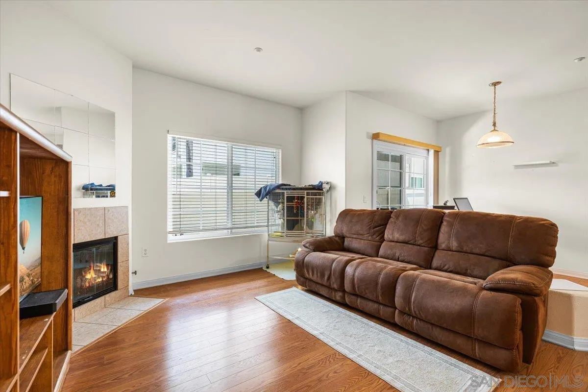 2715 Lake Pointe Drive, Unit 116 Spring Valley, CA 91977 - Photo 19 of 25 a living room with furniture window and a fireplace