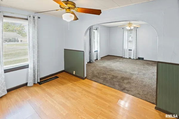 a view of empty room with ceiling fan and window