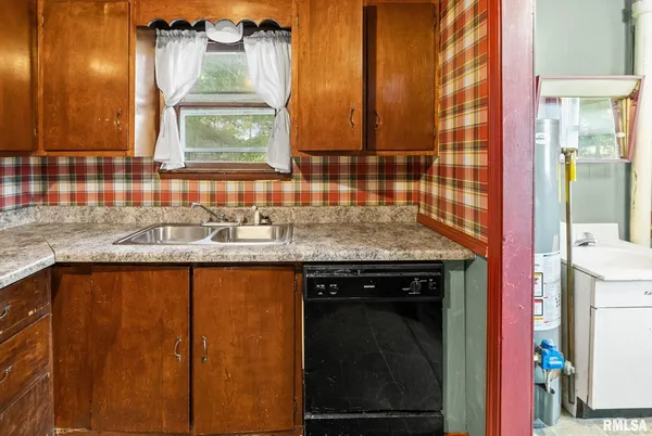 a kitchen with a sink a cabinets and window