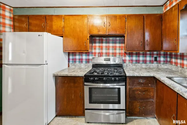 a kitchen with a stove and a refrigerator