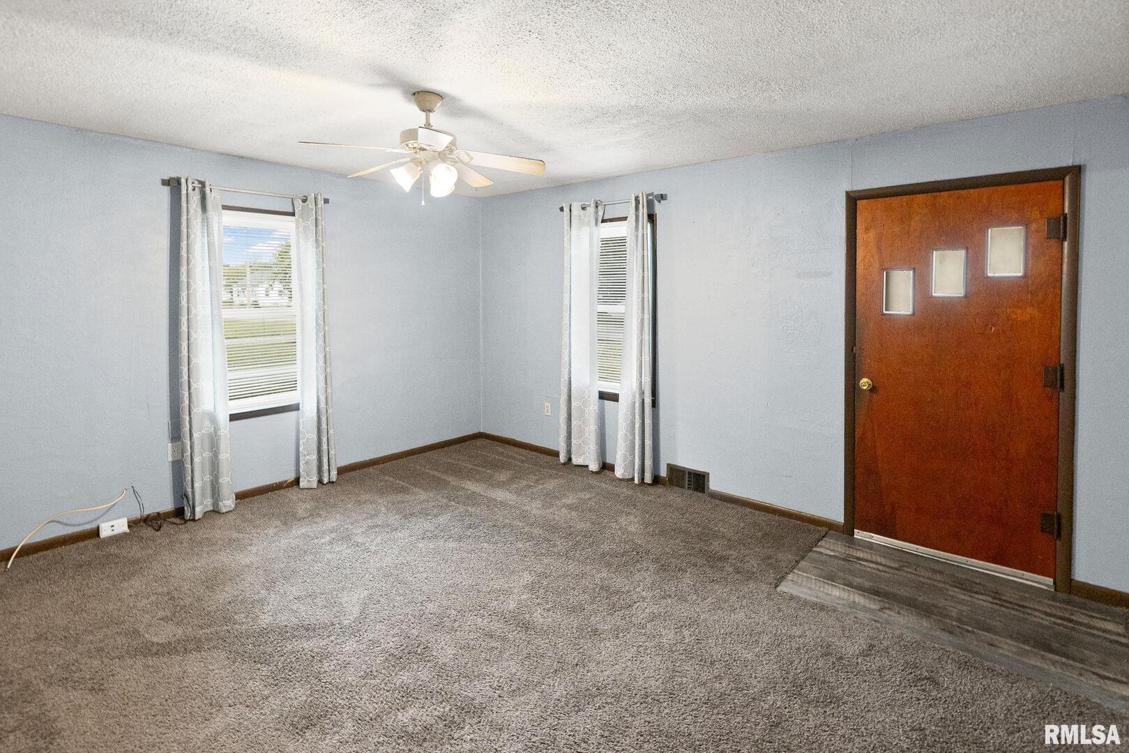 721 West Whittaker Street Salem, IL 62881 - Photo 6 of 25 an empty room with windows and closet