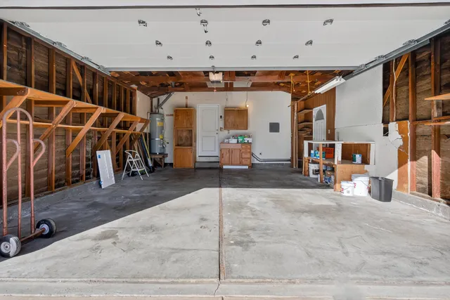 a view of a garage with white cabinets