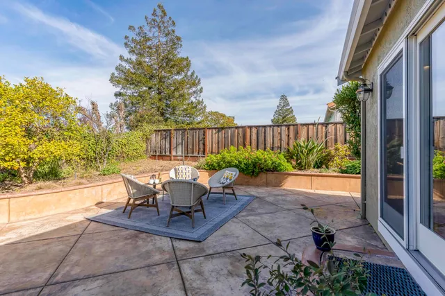a view of a chairs and table in backyard of the house