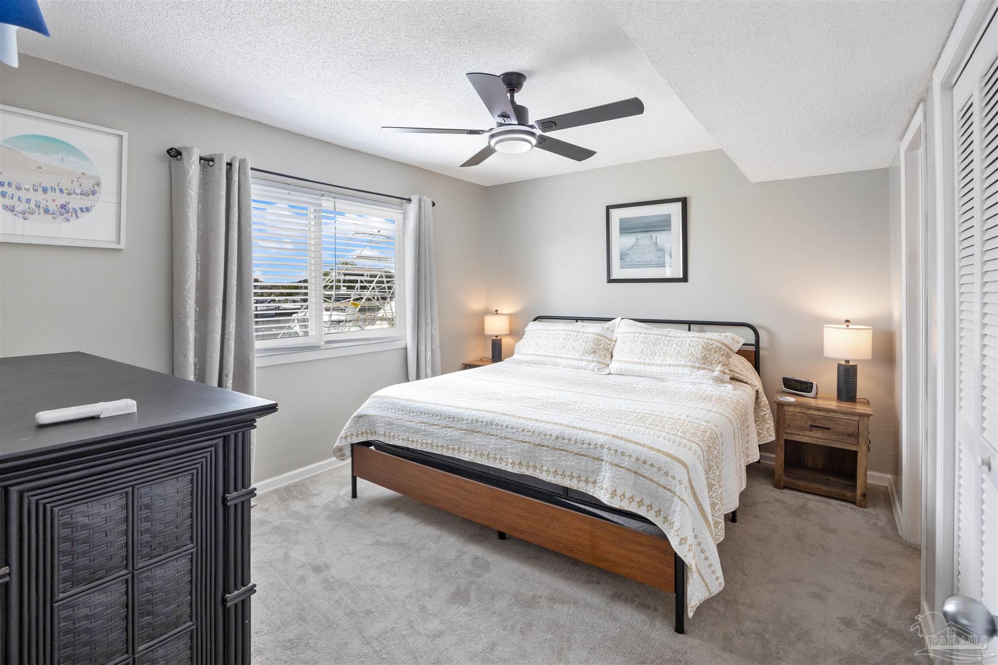 14100 River Road, Unit 122B Perdido Key, FL 32507 - Photo 22 of 46 a bedroom with a bed and a table
