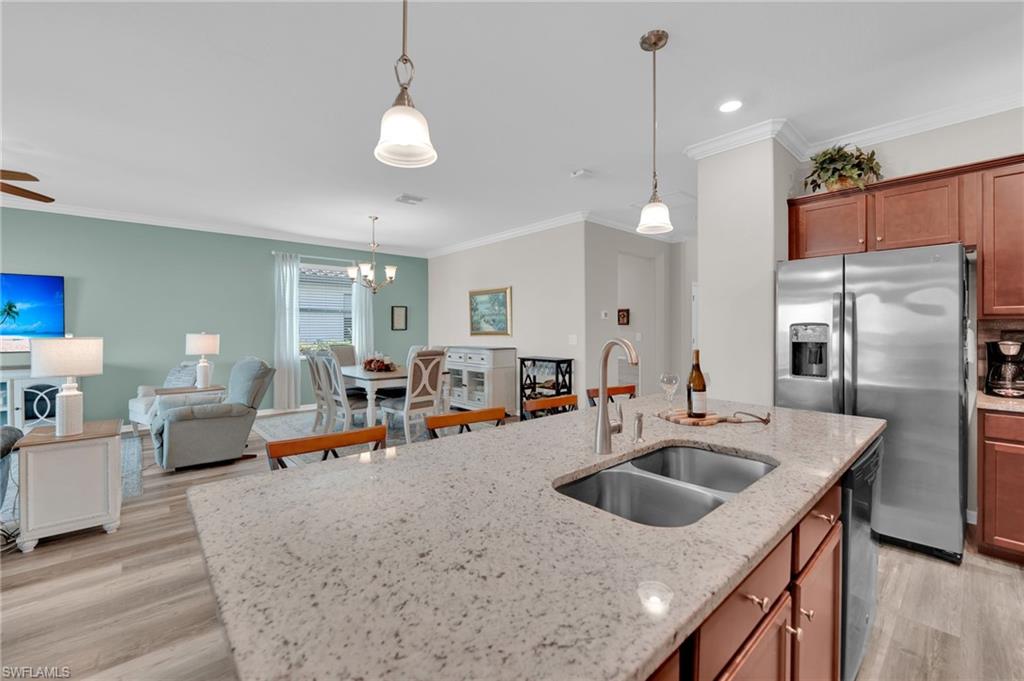 19565 Deming Lane Estero, FL 33928 - Photo 11 of 43 a kitchen with sink refrigerator and cabinets