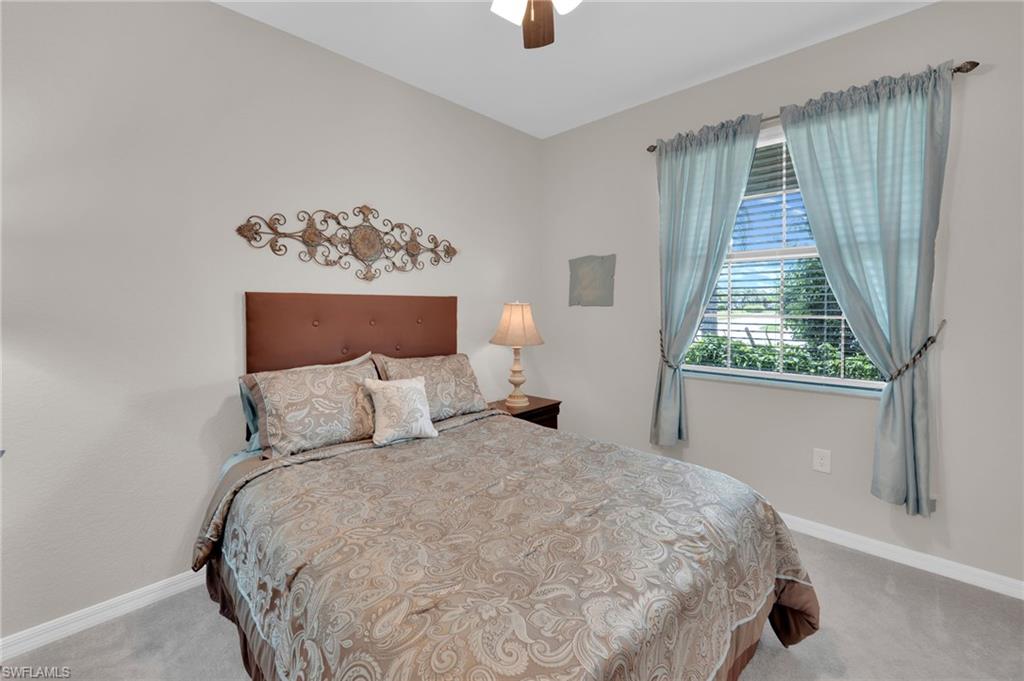 19565 Deming Lane Estero, FL 33928 - Photo 20 of 43 a large bed sitting in a bedroom next to a window