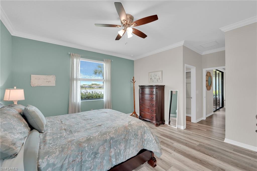 19565 Deming Lane Estero, FL 33928 - Photo 24 of 43 a bedroom with a large bed closet and a window