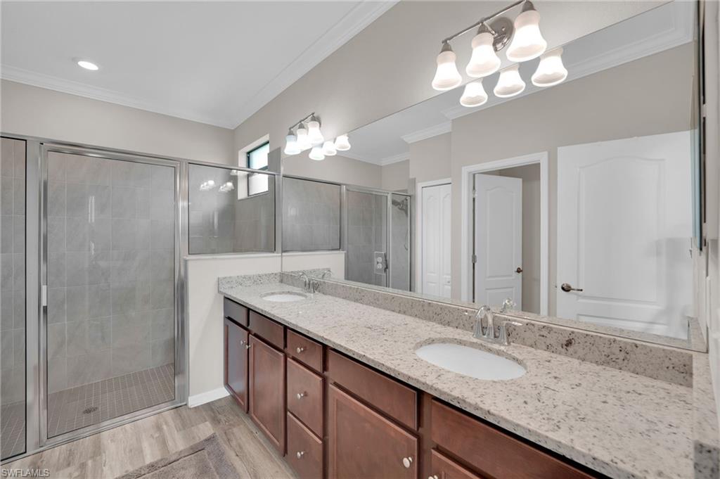 19565 Deming Lane Estero, FL 33928 - Photo 26 of 43 a bathroom with a granite countertop sink a light fixture and a mirror