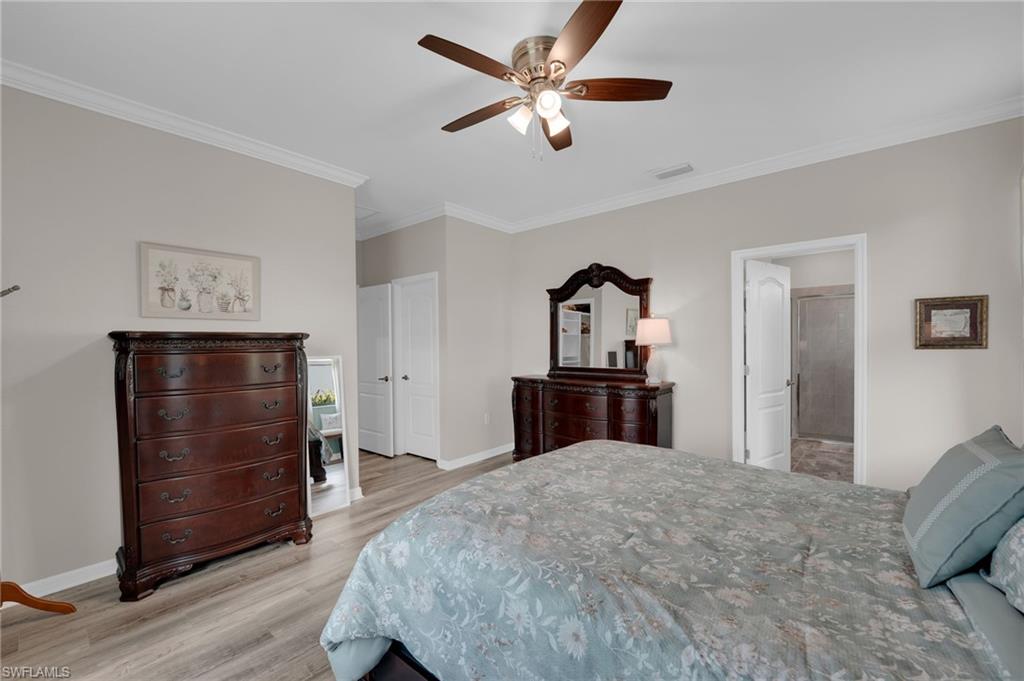 19565 Deming Lane Estero, FL 33928 - Photo 27 of 43 a bedroom with a bed and a dresser