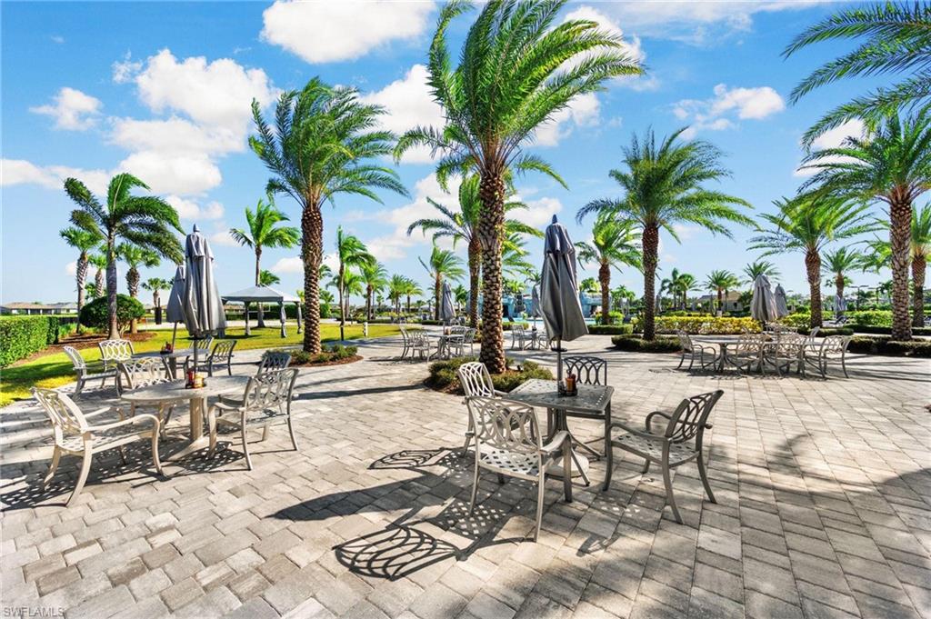 19565 Deming Lane Estero, FL 33928 - Photo 31 of 43 a row of palm trees and swimming pool on the patio