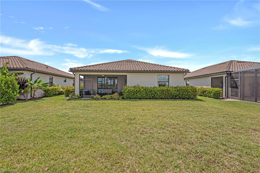 19565 Deming Lane Estero, FL 33928 - Photo 4 of 43 a front view of a house with a garden