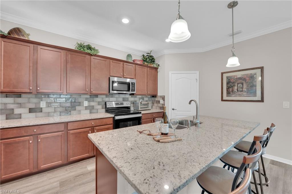 19565 Deming Lane Estero, FL 33928 - Photo 10 of 43 a kitchen with a table chairs sink and microwave