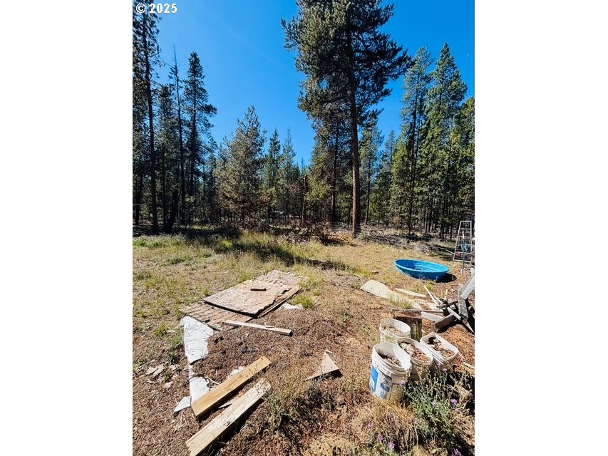52205 Lechner Lane La Pine, OR 97739 - Photo 2 of 14 a view of a backyard with wooden fence and trees