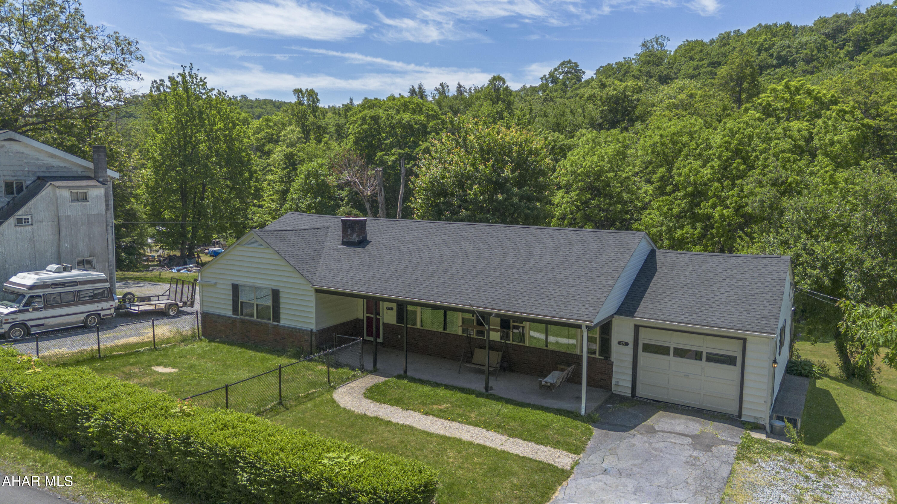 871 Decker Hollow Road Tyrone, PA 16686 - Photo 6 of 35 an aerial view of a house with a yard table and chairs