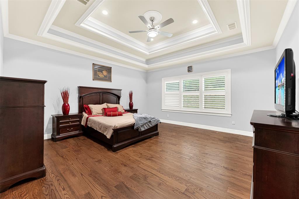 2613 Ranch Court Cedar Hill, TX 75104 - Photo 11 of 29 a bedroom with a bed and a flat screen tv