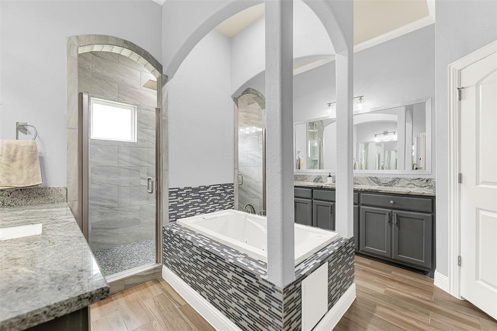 2613 Ranch Court Cedar Hill, TX 75104 - Photo 12 of 29 a bathroom with a tub a mirror and a shower