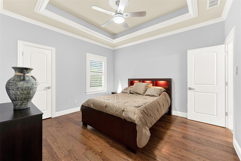 2613 Ranch Court Cedar Hill, TX 75104 - Photo 15 of 29 a bedroom with a bed and a chandelier