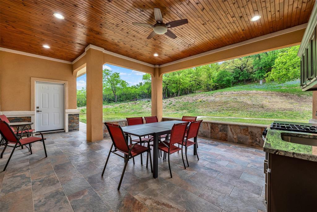 2613 Ranch Court Cedar Hill, TX 75104 - Photo 23 of 29 a view of a patio with a table chairs and a backyard