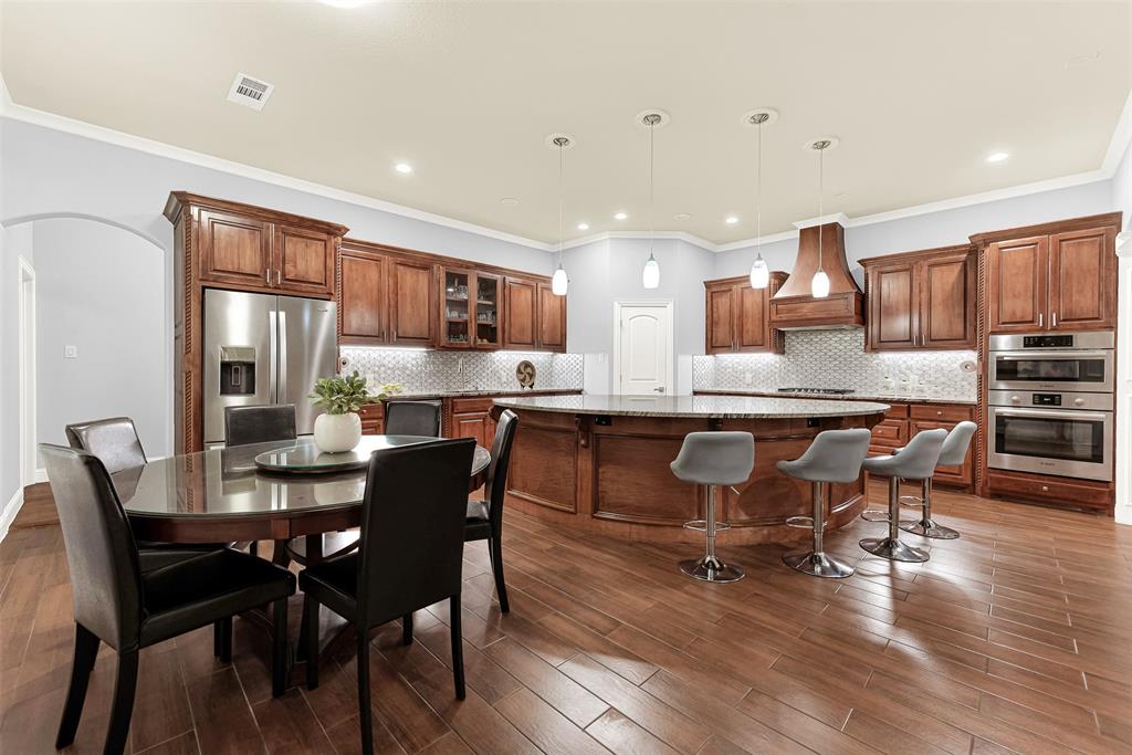 2613 Ranch Court Cedar Hill, TX 75104 - Photo 8 of 29 a dining room with stainless steel appliances kitchen island granite countertop a dining table chairs and view living room