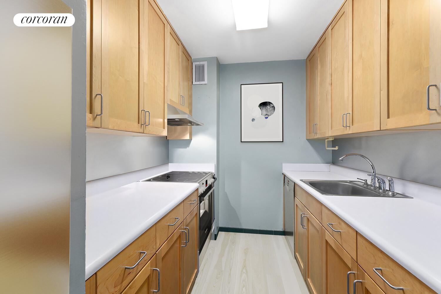 618 Washington Street, Unit GA Manhattan, NY 10014 - Photo 5 of 14 a kitchen with a sink stove and cabinets