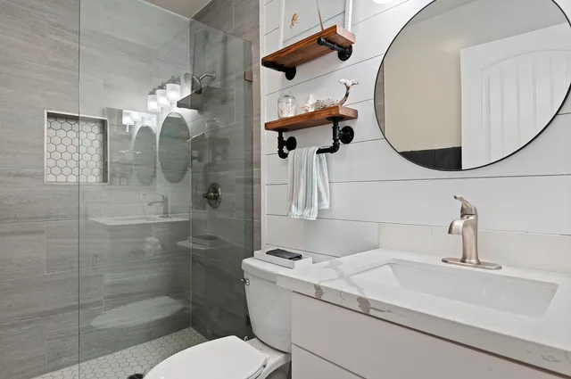 a bathroom with a sink toilet and shower
