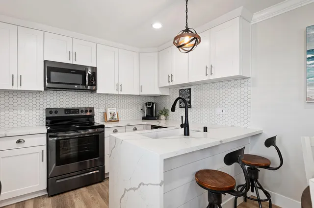 a kitchen with a white cabinets and stove top oven