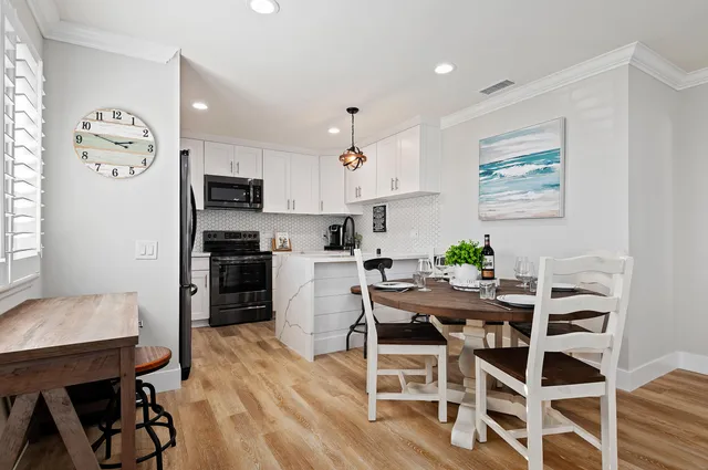 a view of a dining room with furniture and wooden floor