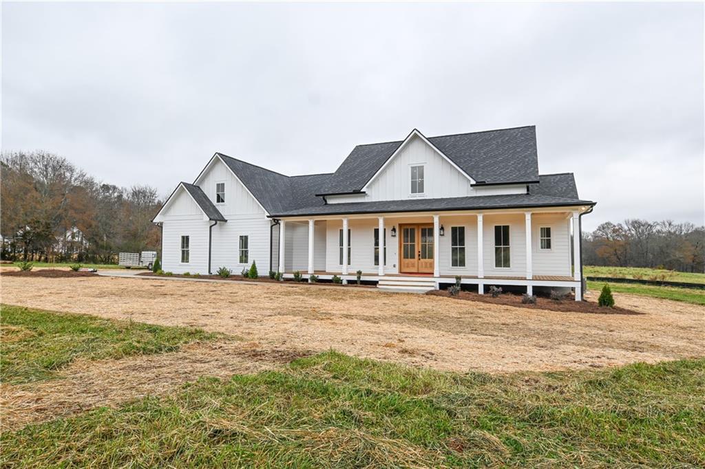 a view of a house with pool and a yard