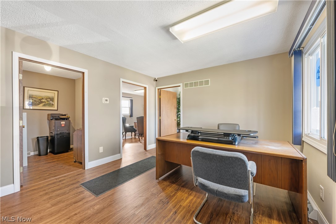 4001 South Cleveland Massillon Road Barberton, OH 44203 - Photo 6 of 25 Home office with wood finished floors and a textured ceiling