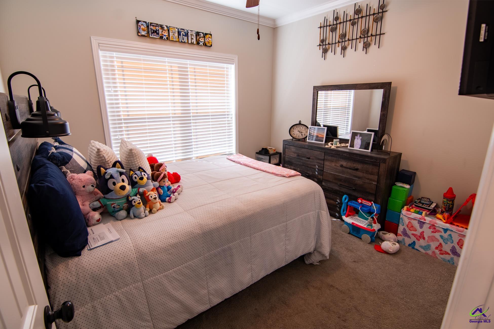 123 Logan's Mill Trail Warner Robins, GA 31093 - Photo 16 of 23 a bed room with a bed and a chair