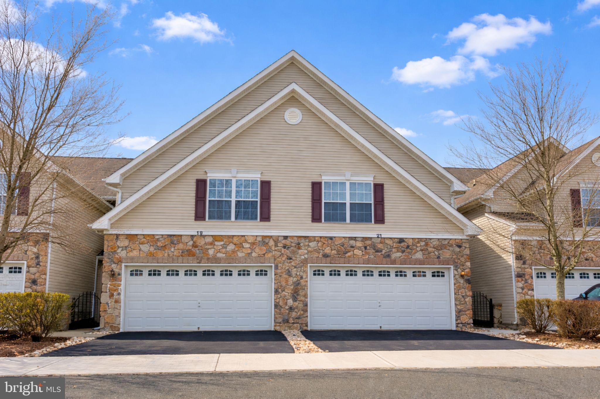21 Miller Circle Pennington, NJ 08534 - Photo 1 of 14 a front view of a house with a parking area