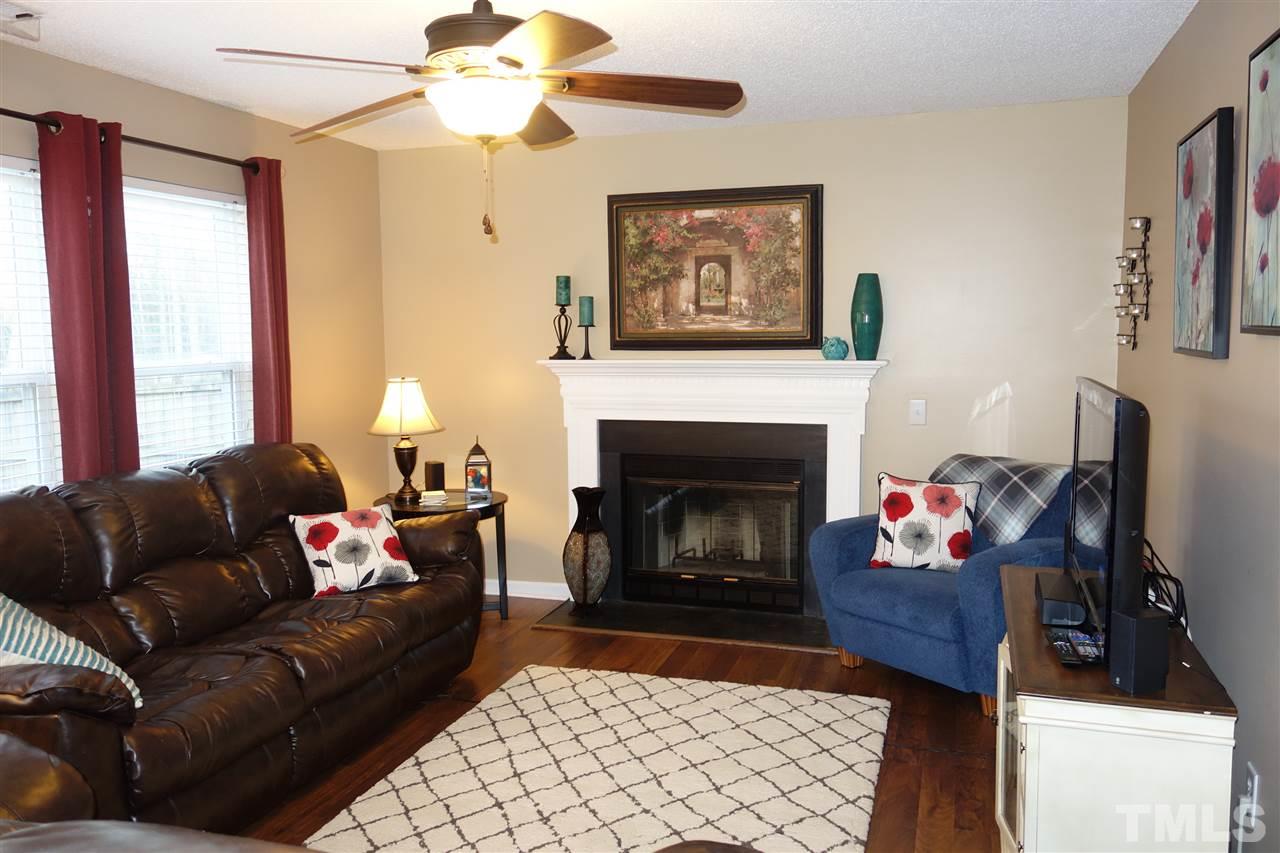 3921 Hopper Street Raleigh, NC 27616 - Photo 4 of 24 a living room with furniture and a fireplace